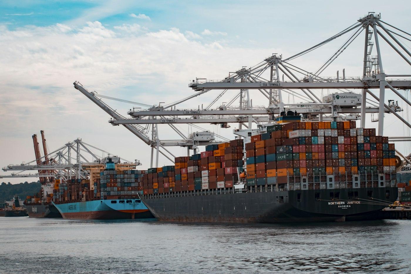Container ship being loaded at a port with gantry cranes
